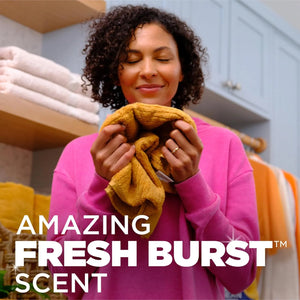 Person enjoying fresh-smelling laundry washed with Arm & Hammer Plus OxiClean Power Paks