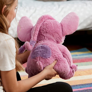 Child holding Disney Angel plush toy from the back, showing soft pink texture, floppy ears, and embroidered wings.