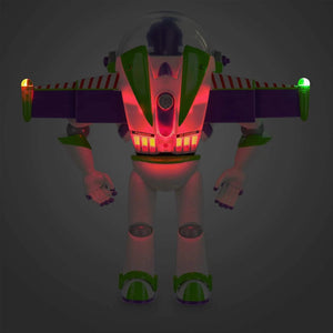 Disney Store Buzz Lightyear interactive talking action figure with wings extended and jetpack lights glowing in the dark