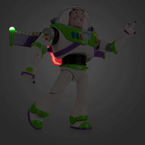 Side view of Buzz Lightyear interactive action figure with glowing lights and extended wings in dark setting