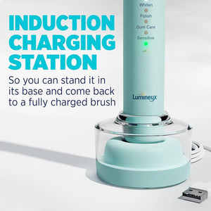 Lumineux electric toothbrush placed on induction charging station with USB cord