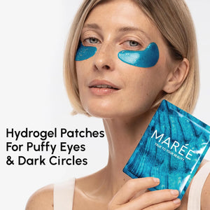 Woman wearing blue hydrogel under eye patches holding MAREE packaging for puffy eyes and dark circles.