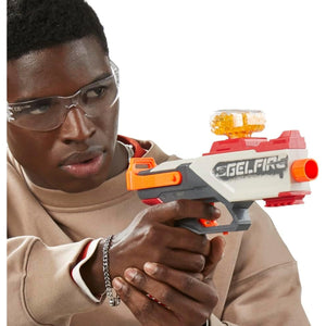 Teen wearing protective eyewear aiming Nerf Pro Gelfire Legion spring action blaster