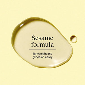 Close-up of Neutrogena Body Oil Light Sesame Formula texture on light background.