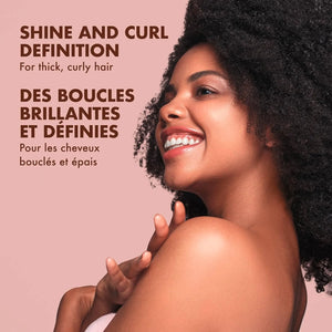 Model with thick curly hair showing shine and curl definition after using Shea Moisture Coconut and Hibiscus hair care products