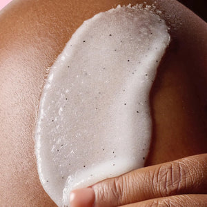 Close-up of Tree Hut Shea Sugar Scrub texture applied on skin showing exfoliating sugar granules and hydrating formula.