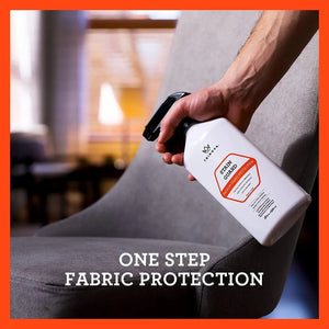 TriNova Fabric Protector Spray 18oz being applied to upholstered chair for stain and fabric protection.