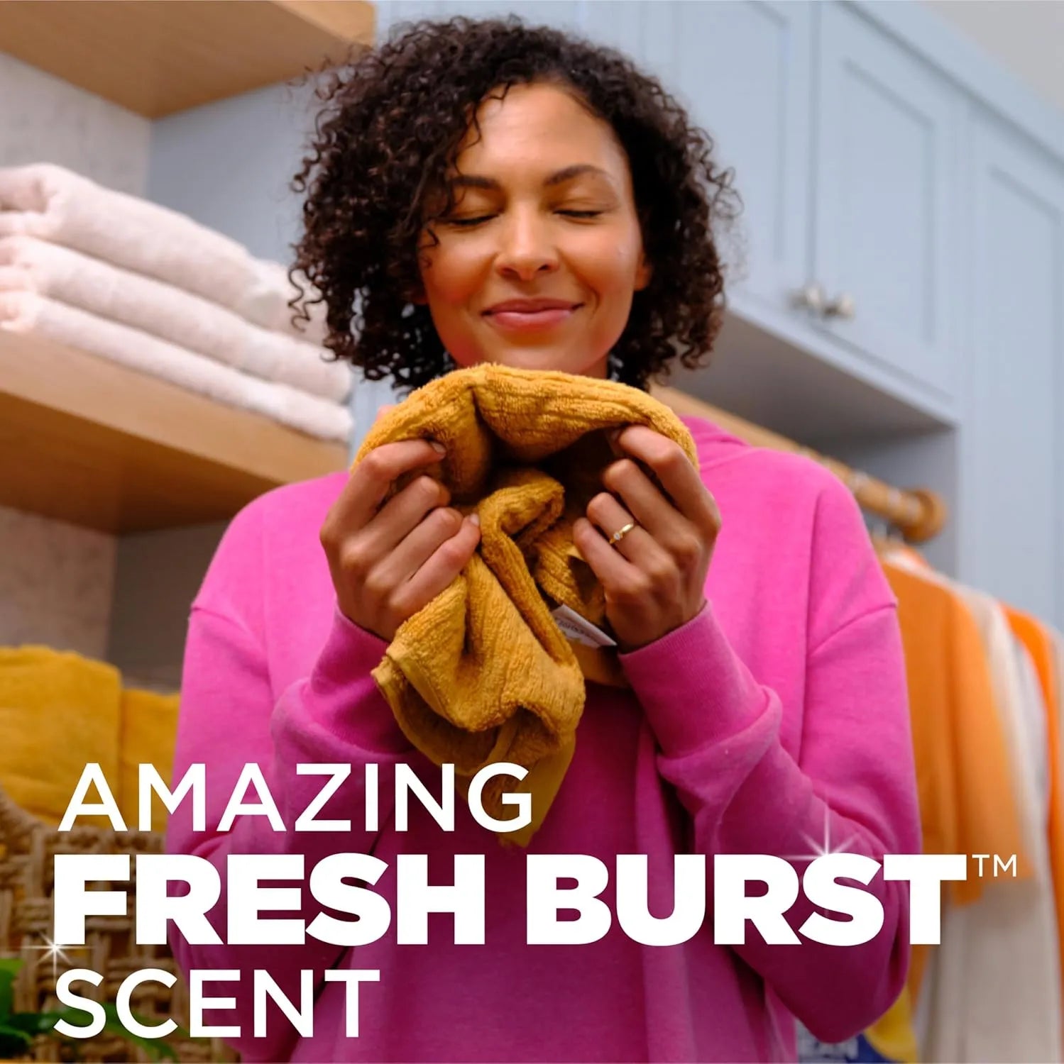 Person enjoying fresh-smelling laundry washed with Arm & Hammer Plus OxiClean Power Paks