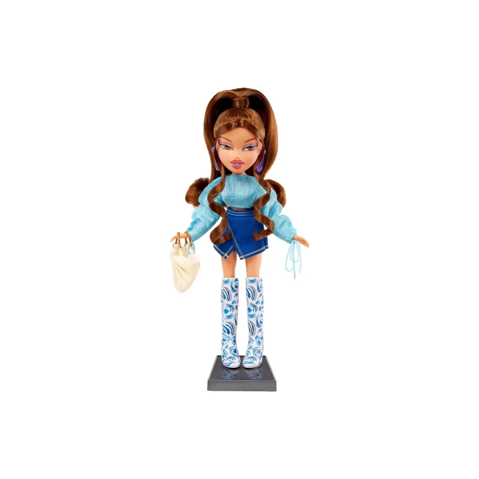 Bratz x Cult Gaia Yasmin doll wearing blue top, denim skirt, and patterned knee-high boots