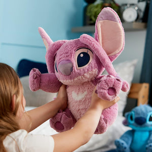 Child hugging Disney Angel medium soft toy, highlighting fluffy pink fabric, large floppy ears, and embroidered eyes.