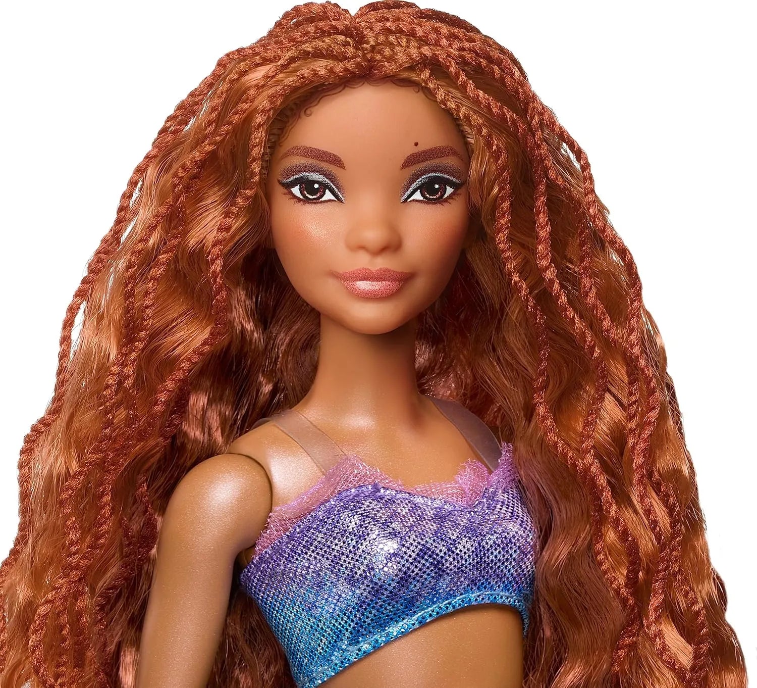 Close-up of Ariel mermaid doll from Disney The Little Mermaid Ultimate Sisters 7-Pack with long red hair and shimmering ocean-inspired outfit.