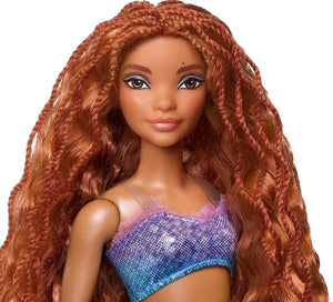 Close-up of Ariel mermaid doll from Disney The Little Mermaid Ultimate Sisters 7-Pack with long red hair and shimmering ocean-inspired outfit.