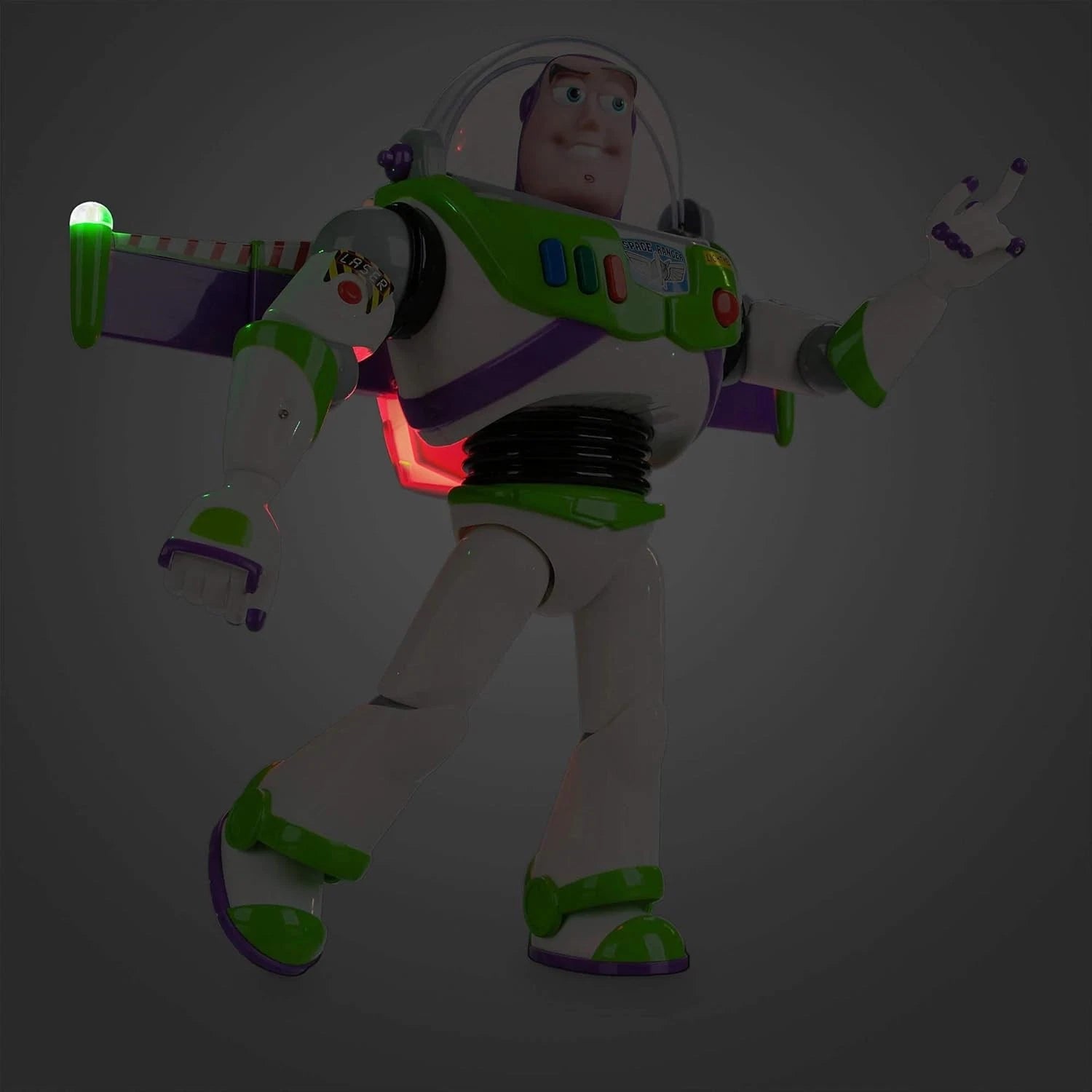 Side view of Buzz Lightyear interactive action figure with glowing lights and extended wings in dark setting