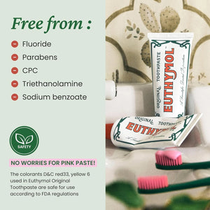 Euthymol natural fluoride-free pink toothpaste in recyclable aluminum tube with “free from fluoride, parabens and CPC” ingredient highlights displayed in a bathroom setting.