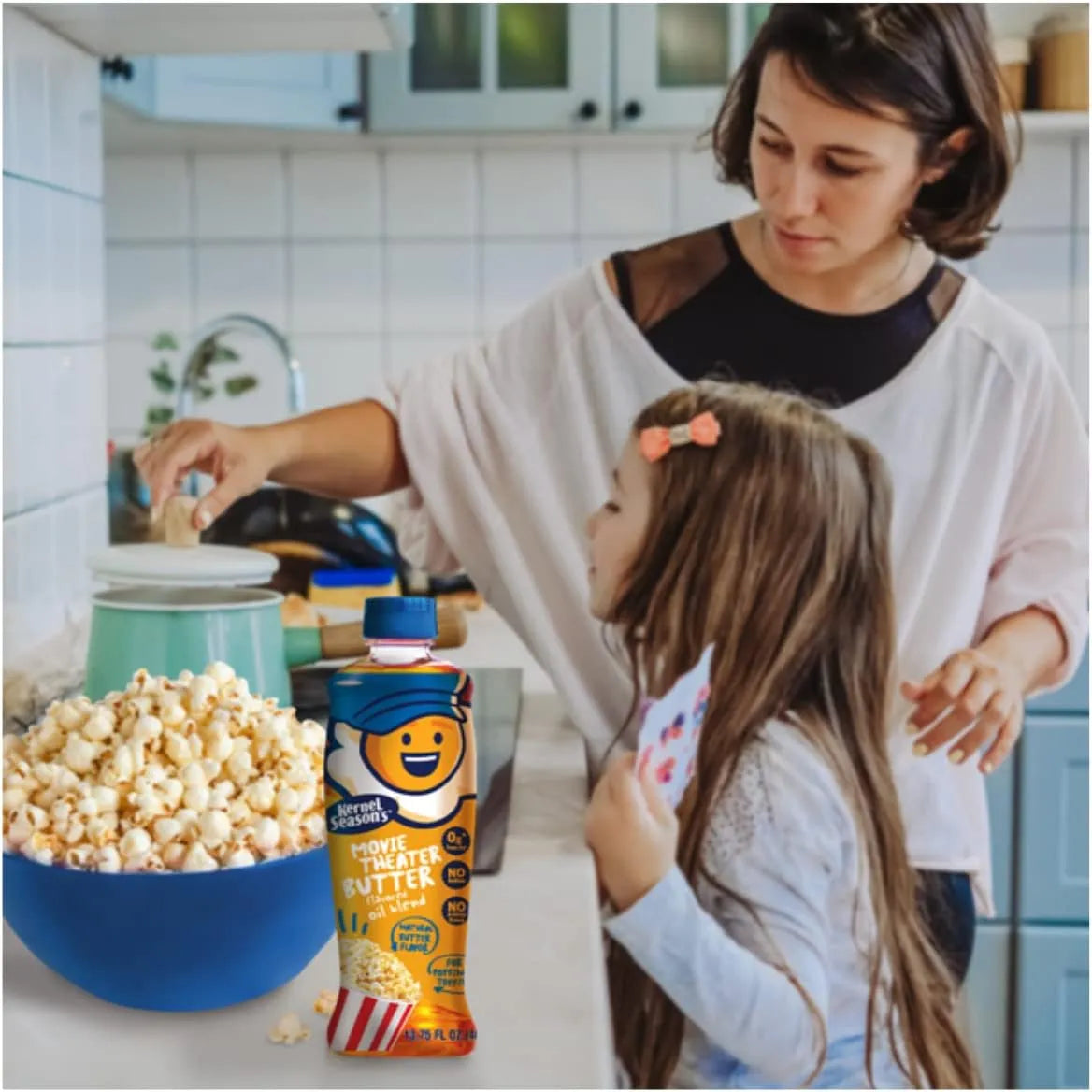 Kernel Movie Theater Butter bottle next to freshly popped popcorn during family movie night in kitchen