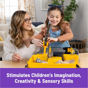Child playing with Kinetic Sand construction sandbox featuring working crane and toy truck, creative sensory STEM toy for kids.