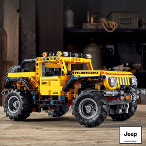 Close-up view of LEGO Technic Jeep Wrangler 42122 showing Rubicon branding, front grille, and off-road tires