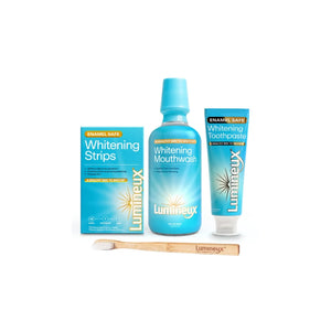 Lumineux peroxide free teeth whitening kit including whitening strips, mouthwash, toothpaste, and bamboo toothbrush