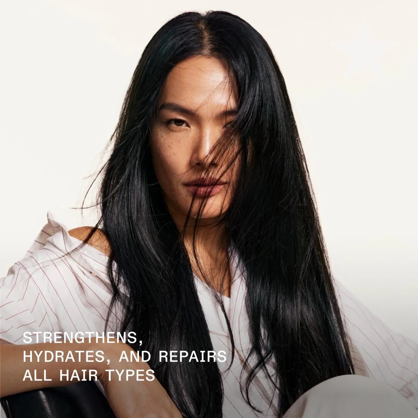 Model with long dark hair showcasing smooth and shiny appearance.