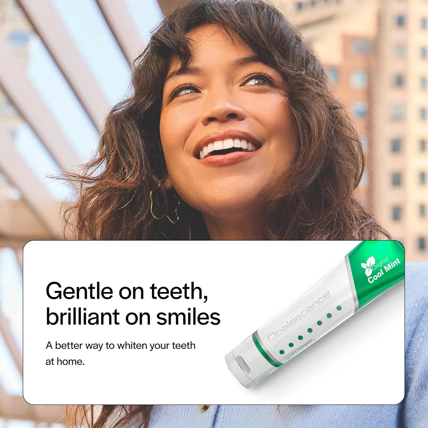 Woman smiling outdoors with Opalescence Whitening Toothpaste Cool Mint product banner displayed.