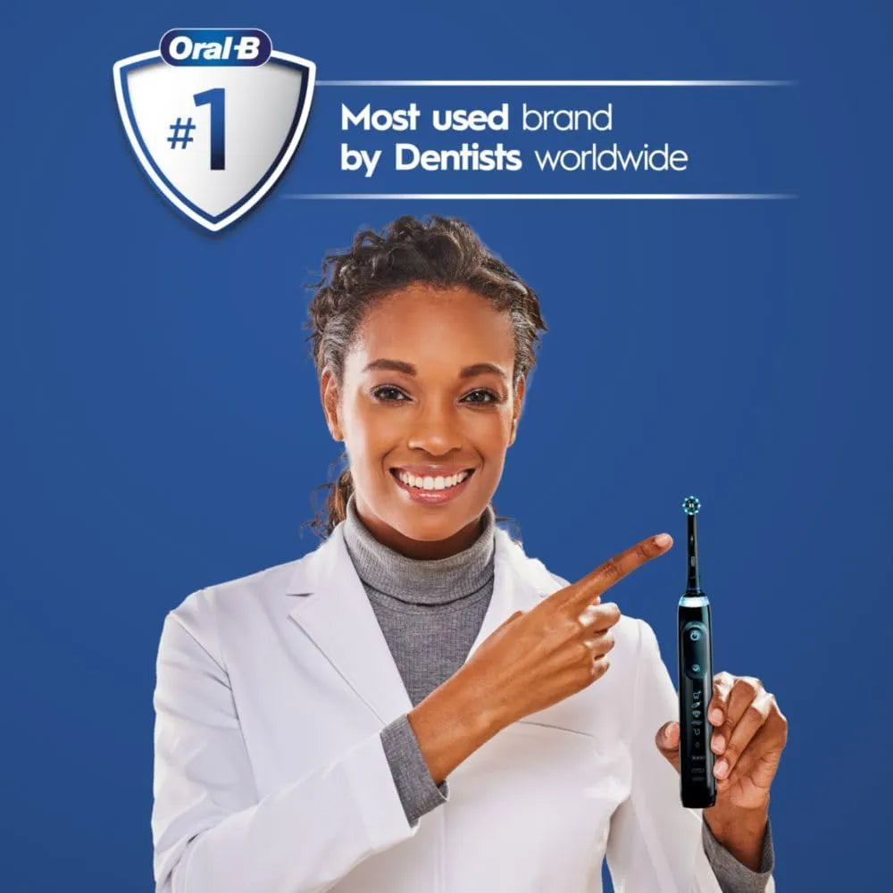 Woman in white coat holding Oral-B Genius X Limited electric toothbrush in midnight black against blue background.