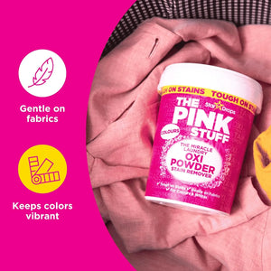 The Pink Stuff Miracle Laundry Oxi Powder for Colours placed on clothing, highlighting gentle on fabrics and helps keep colors vibrant