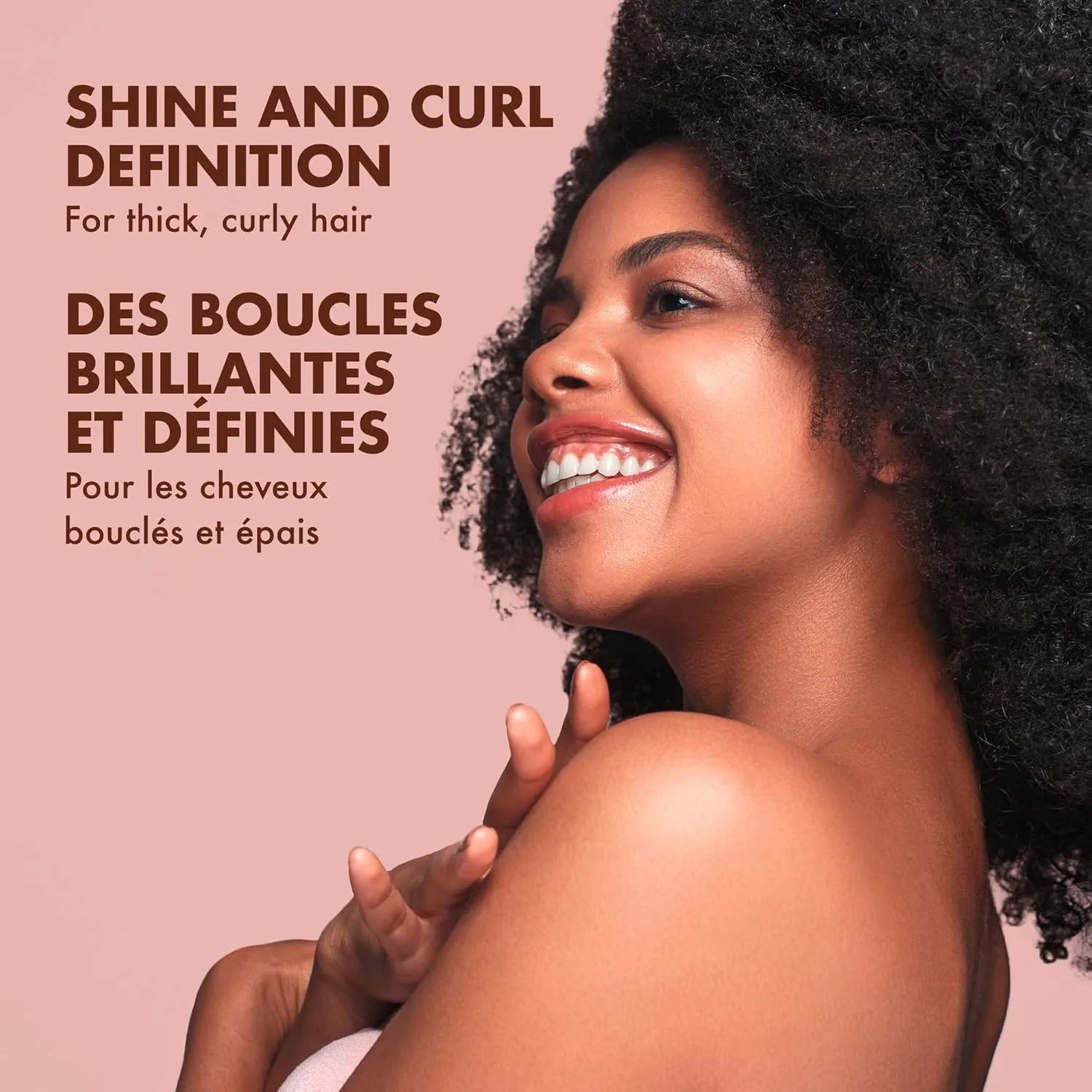 Model with thick curly hair showing shine and curl definition after using Shea Moisture Coconut and Hibiscus hair care products