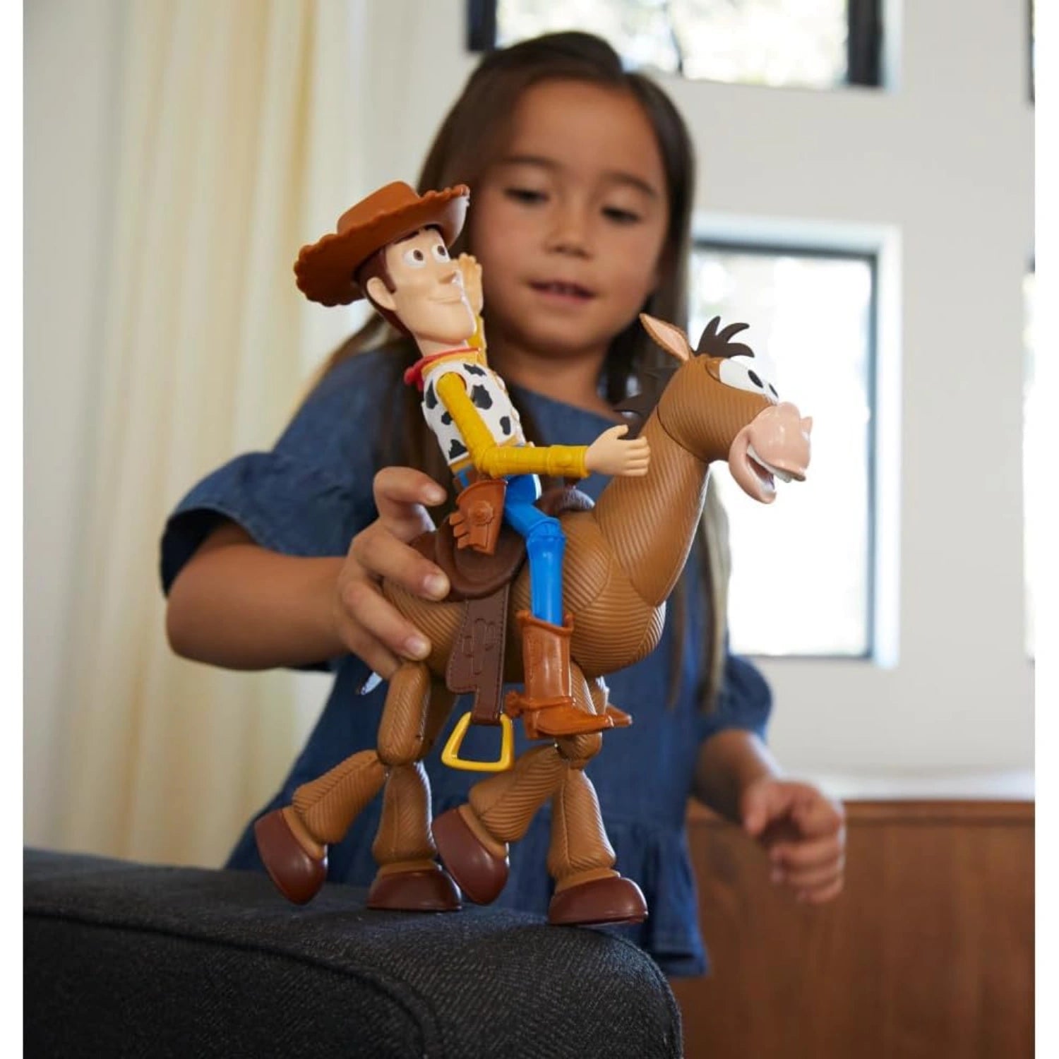 Child playing with Woody and Bullseye Toy Story 4 figures for imaginative storytelling play.